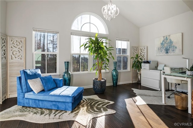 interior space with dark hardwood / wood-style floors, an inviting chandelier, and high vaulted ceiling