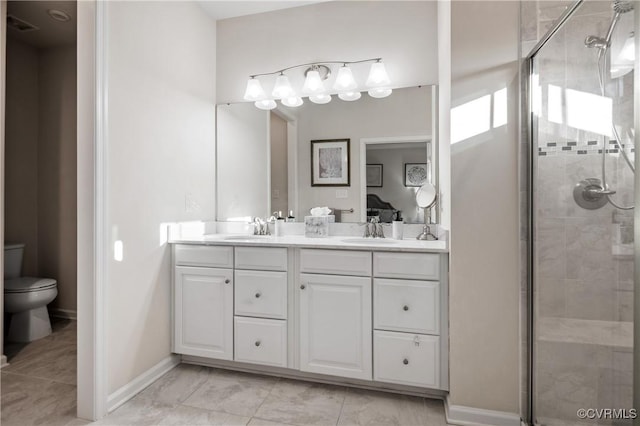 bathroom with vanity, toilet, and a shower with shower door