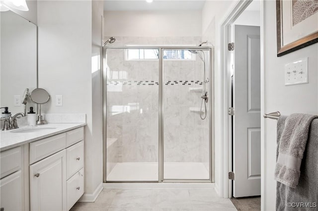 bathroom with vanity and a shower with door