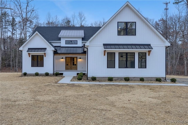 modern farmhouse style home with a front yard