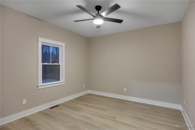 unfurnished room with baseboards, visible vents, light wood-style flooring, and a ceiling fan