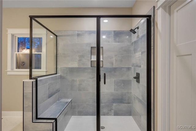 bathroom featuring a shower with door