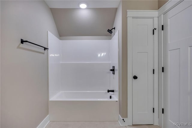 full bath featuring tile patterned floors, shower / bath combination, and lofted ceiling