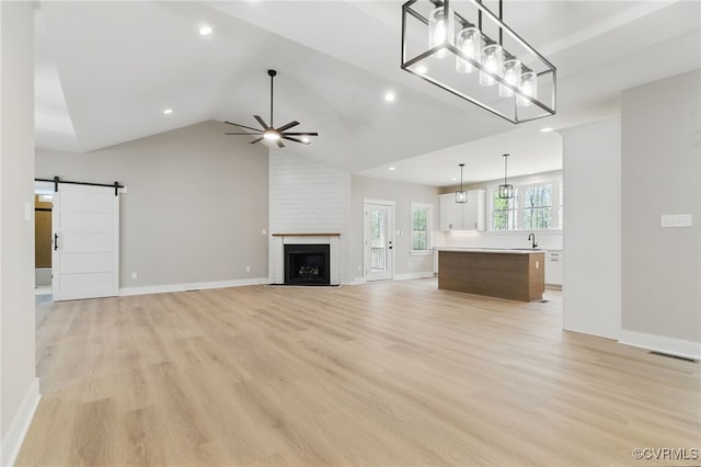 2280 Hensley Rd, Mineral, VA 23117 - unfurnished living room featuring ceiling fan, a barn door, a sink, light wood-type flooring, and recessed lighting