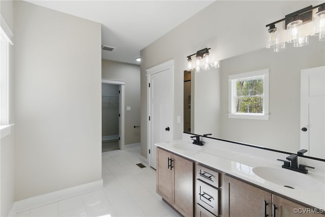 2280 Hensley Rd, Mineral, VA 23117 - full bath featuring double vanity, a walk in closet, tile patterned floors, and baseboards