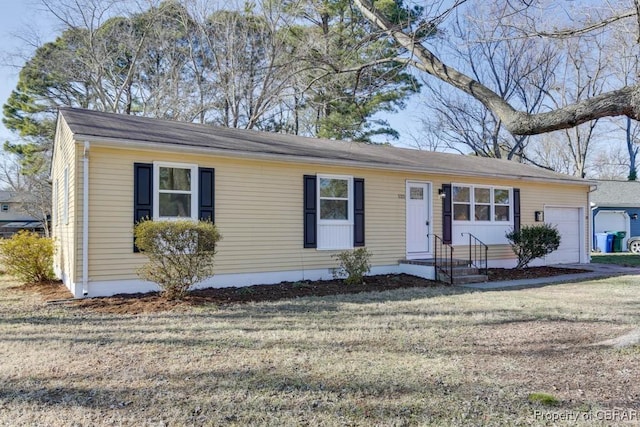 ranch-style home with a garage and a front yard