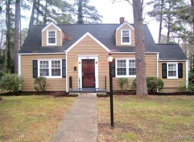 cape cod-style house featuring a front yard