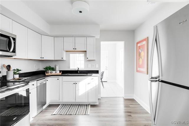 kitchen with white cabinetry, sink, and appliances with stainless steel finishes