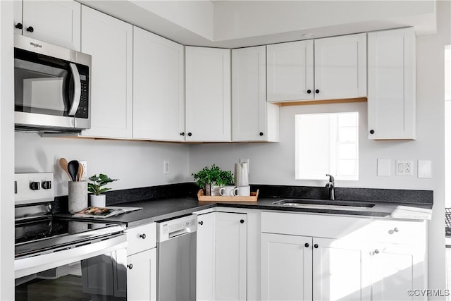 kitchen featuring sink, white cabinets, and appliances with stainless steel finishes