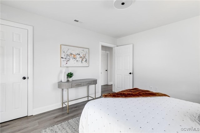 bedroom with wood-type flooring