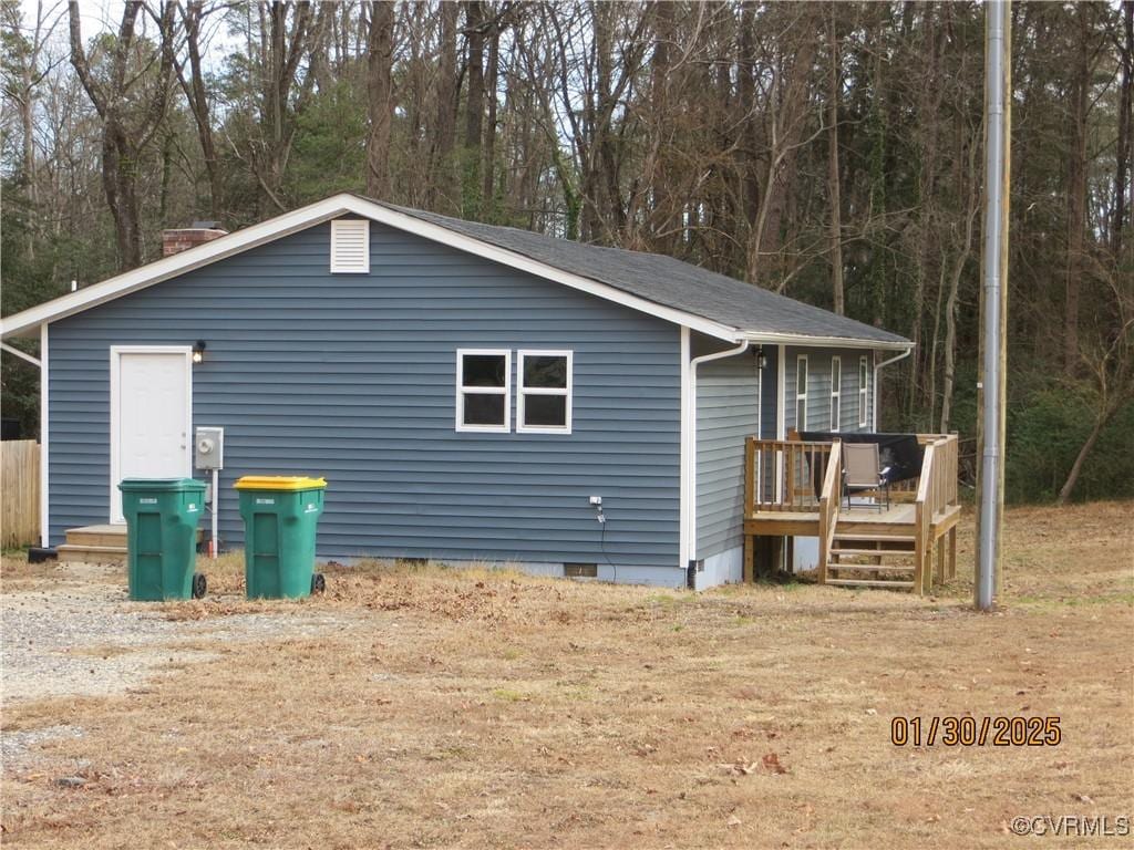 view of property exterior with a wooden deck