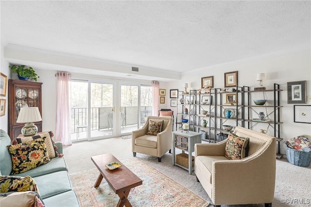 living room featuring light carpet, ornamental molding, and a textured ceiling