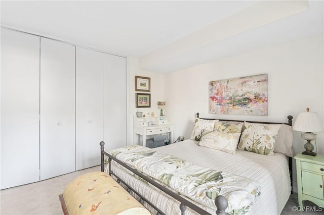 bedroom with light carpet and a closet