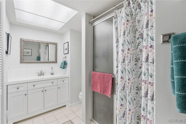 bathroom featuring vanity, toilet, tile patterned flooring, and a shower with door