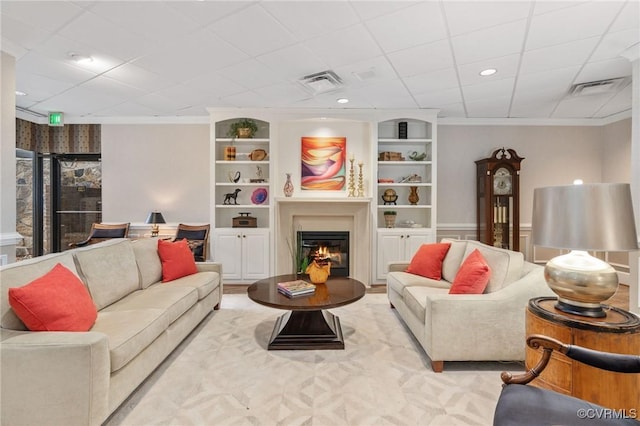 living room featuring ornamental molding and built in features