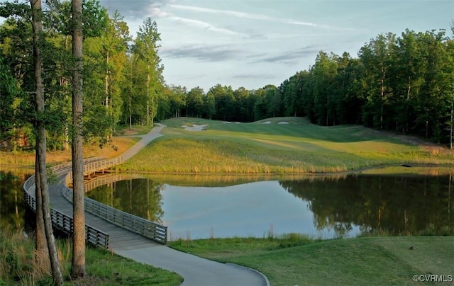 view of property's community featuring a water view and a lawn