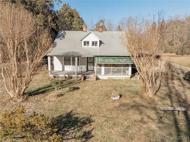 view of front of house with a porch, a sunroom, and a front yard