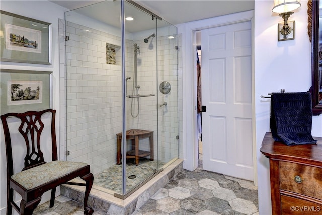 bathroom with a shower with door