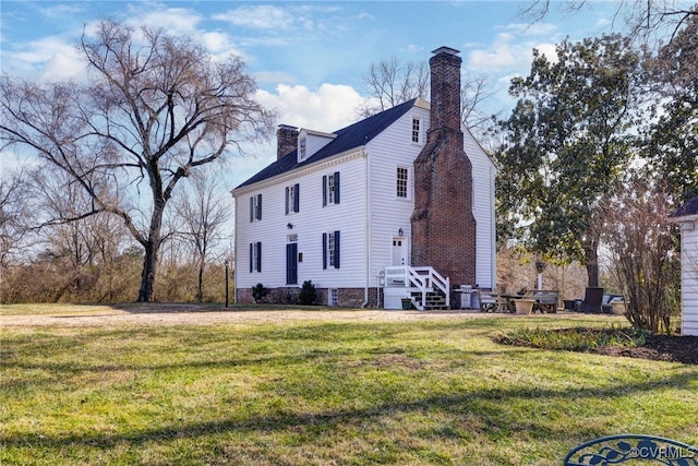 view of side of home featuring a lawn