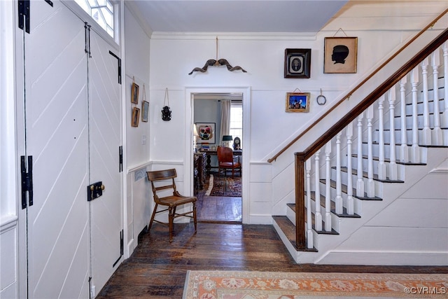 entrance foyer featuring crown molding and dark hardwood / wood-style floors