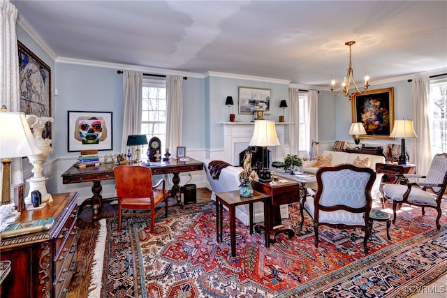 living room with ornamental molding and a chandelier