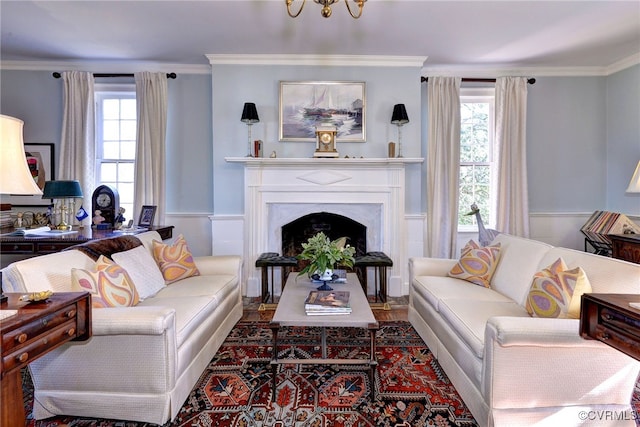 living room with ornamental molding and a premium fireplace