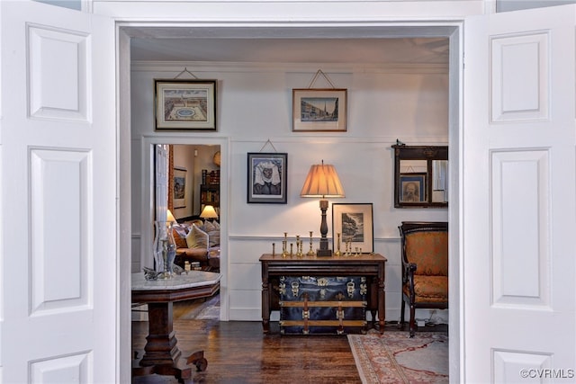 hallway with crown molding and dark wood-type flooring