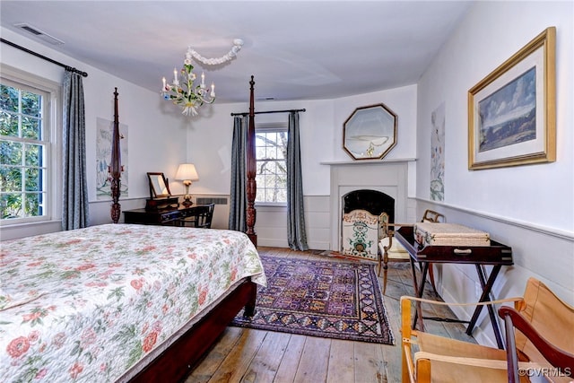 bedroom featuring hardwood / wood-style flooring and a chandelier