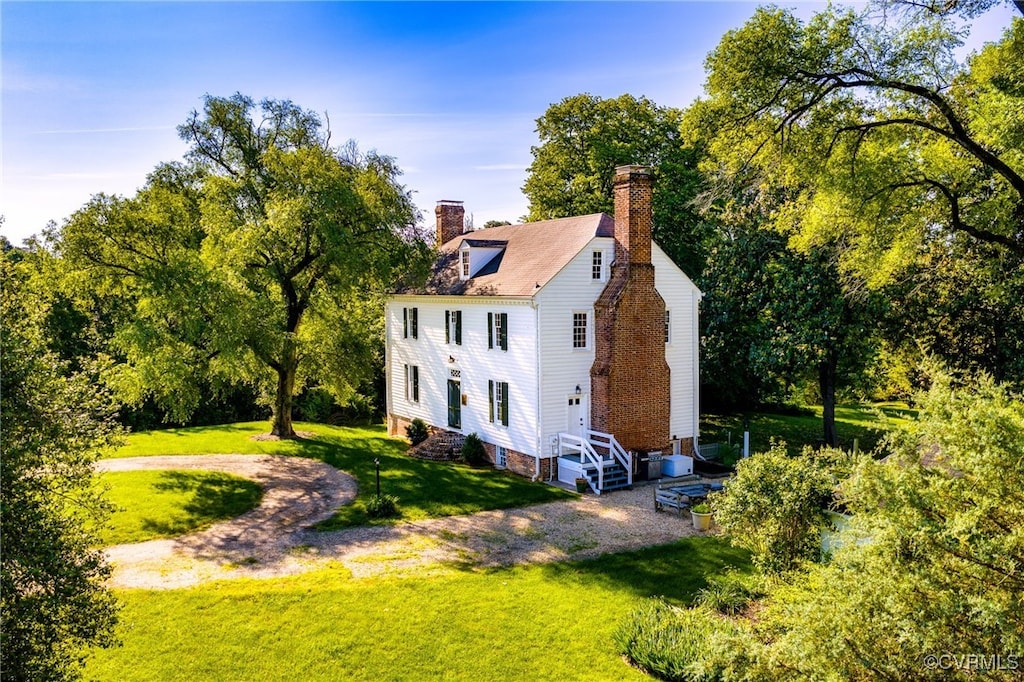 15318 James Madison Pkwy, King George, VA 22485 - view of side of property featuring a lawn, a chimney, and view of wooded area