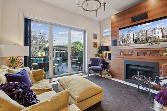 carpeted living room with a notable chandelier