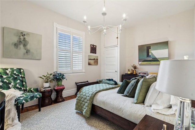 bedroom featuring hardwood / wood-style floors and a notable chandelier