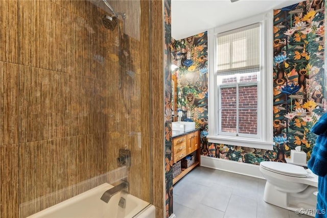 full bathroom with tiled shower / bath combo, vanity, tile patterned flooring, and toilet