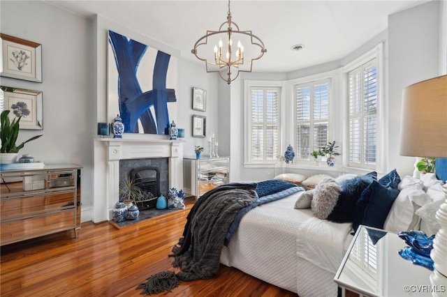 bedroom with wood-type flooring and a chandelier