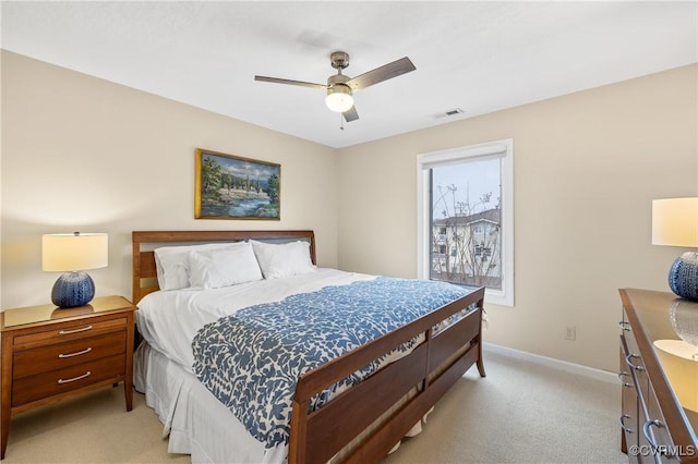 bedroom with ceiling fan and light carpet