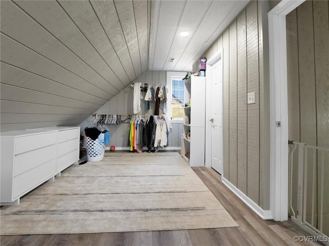 bonus room featuring lofted ceiling, light hardwood / wood-style flooring, and wooden ceiling