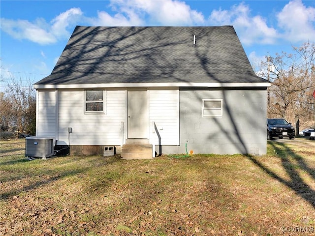 back of house with a yard and central AC