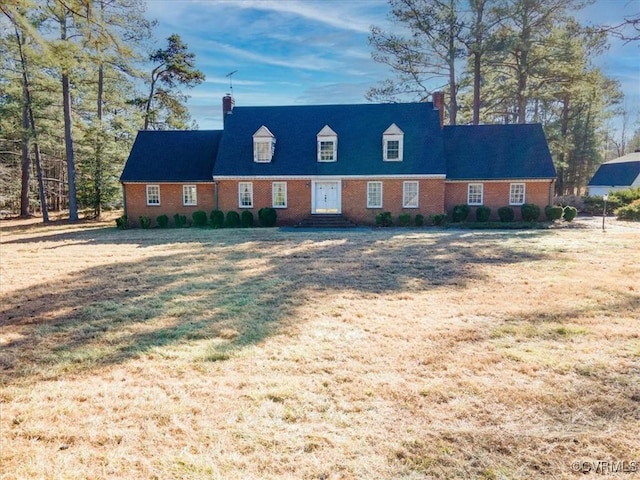 cape cod house with a front lawn