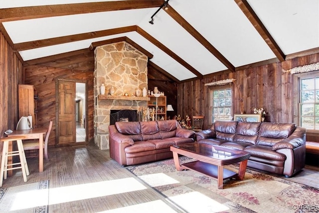 living room with wood-type flooring, a fireplace, high vaulted ceiling, wooden walls, and beam ceiling