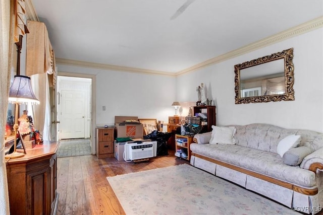 living room with hardwood / wood-style flooring and ornamental molding