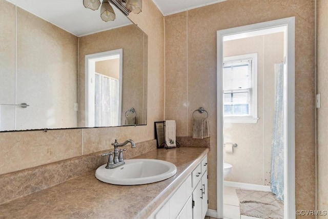 bathroom featuring toilet and vanity