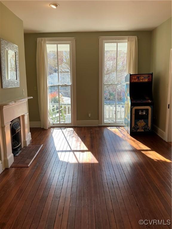 unfurnished living room featuring dark wood-type flooring