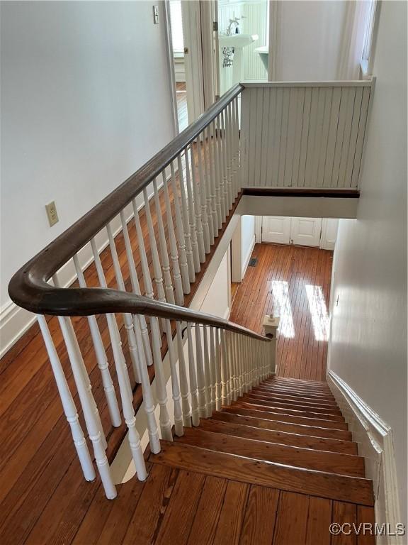 stairs featuring wood-type flooring