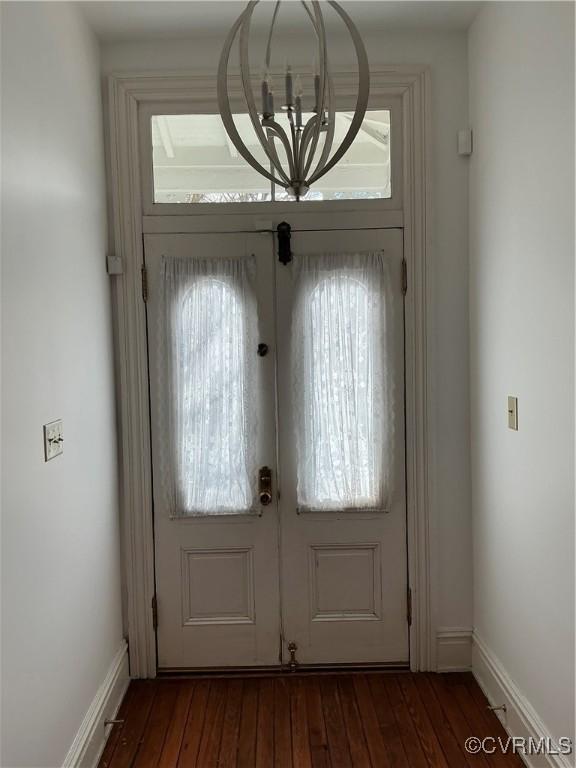 doorway to outside featuring baseboards, hardwood / wood-style floors, and french doors