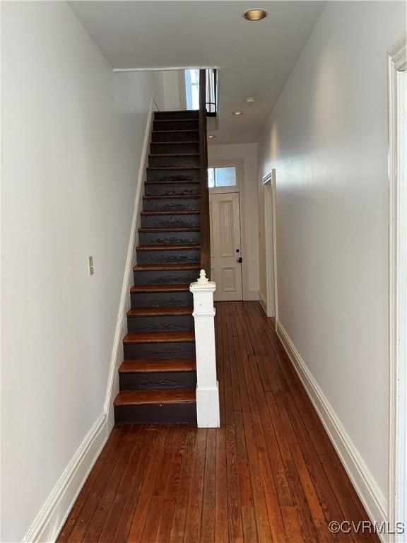 stairway with hardwood / wood-style floors