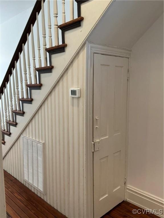 interior space featuring baseboards and wood finished floors