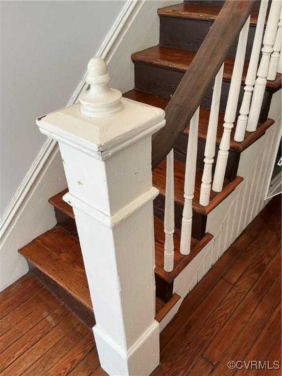 staircase with hardwood / wood-style flooring