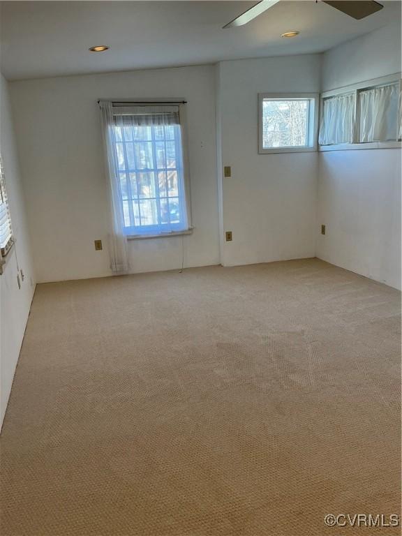 carpeted empty room with ceiling fan