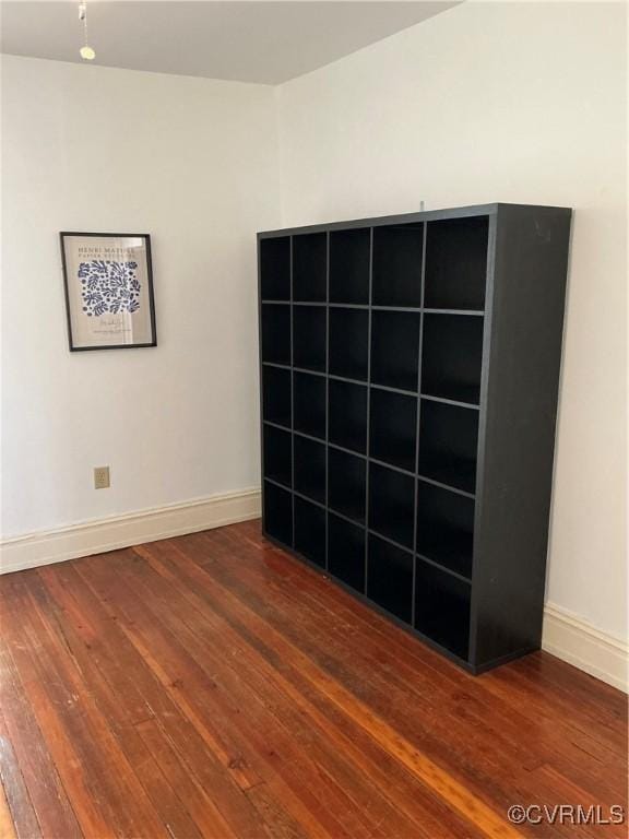 empty room with dark hardwood / wood-style flooring