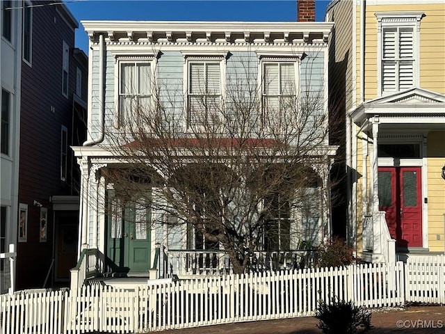 italianate home with a fenced front yard