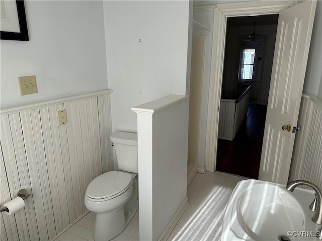 bathroom featuring toilet and tile patterned floors